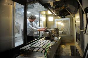 John Brown, a NuVasive(R) Manufacturing, LLC., (NML) employee, sets the PEEK bar in a Haas mill for the product's first machining operation in Dayton, Ohio.
Photo Credit: Erik Schelkun, Elsestar Images.