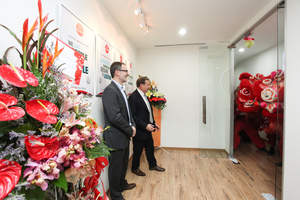Arkadin's VP of Client Care Frederic Athenosy (L) and CEO Olivier de Puymorin (R) greet Malaysian Lion Dancers at a reception to open Arkadin's new Global Customer Services Operation in Malaysia.