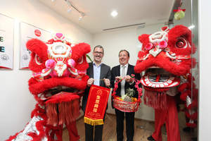 Arkadin's VP of Client Care Frederic Athenosy (L) and CEO Olivier de Puymorin (R) greet Malaysian Lion Dancers at a reception to open Arkadin's new Global Customer Services Operation in Malaysia.