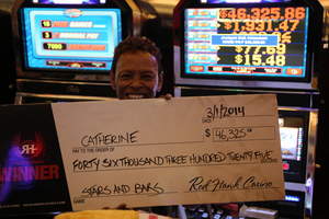 Catherine, from Sacramento, Calif., celebrates a $46,325 penny slot jackpot at Red Hawk Casino.