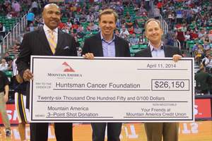 Sterling Nielsen of Mountain America Credit Union (r.) and Ron Boone, Utah Jazz broadcaster (l.) present a $26,150 check to Paul Huntsman, who represented the Huntsman family at the Portland Trailblazers game on April 11, 2014.