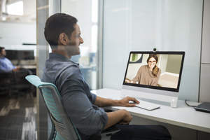 Cisco's new DX80 has a larger (23-inch) screen and comes equipped with the new Intelligent Audio feature. This feature would ensure that the colleague on the screen would not hear noise from the meeting going on in the background of this shot -- even if that meeting got very loud.