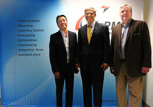 Revenue Management Systems’ Lawrence Siao, Vice President of Marketing – Asia (Left) and Scott Schade, CEO (Right) stand with Washington Governor Jay Inslee (Center) at their Seattle, Washington Headquarters