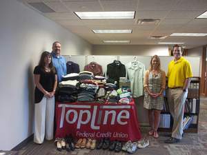 TopLine employees fill CEAP’s closet and Keystone’s personal care shelves during “Donating for Denim Days”
