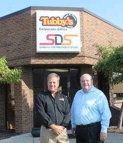 Owners of Tubby's Sub Shops, CEO Robert Paganes, at left, and Executive VP Bill Kiryakoza stand outside the company's headquarters.