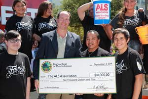 Barona Tribal Chairman Clifford LaChappa presents check to Steve Becvar, executive director of the ALS Great San Diego Chapter with students from Barona Indian Charter School.