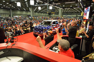 DALLAS (September 7, 2014) - Crowd celebrates winning $250,000 bid at a charity auction during the Mecum Dallas Auction. All proceeds of the sale benefit The MobilityWorks Foundation and will help deserving veterans afford wheelchair-accessible vehicles and other adaptive driving devices.