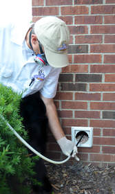 A Dryer Vent Wizard technician removes lint clogging a dryer vent to help ensure fire safety and improve dryer efficiency.
