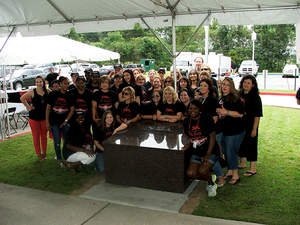 Employees at Saia's Houma, La. office pose for a group photo with the time capsule the company buried this week.