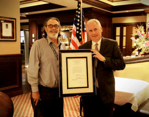 Shingle Springs Band of Miwok Indians Chairman Nicholas Fonseca presents Rep. Tom McClintock, R-Calif., with a redline copy of Public Law 113-197, signed by President Barack Obama.