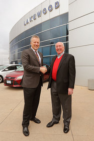Greg Miller, CEO, Larry H. Miller Group of Companies shakes hands with Robert Liedel, former owner of Lakewood Fordland.