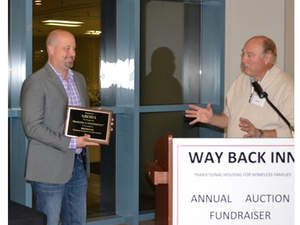 Dave Caple accepts award from Way Back Inn for ABODA employees
