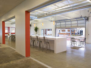 THE Campus has full-height windows and overhead doors that reveal interior work spaces to the signature Bixby Retreat.
