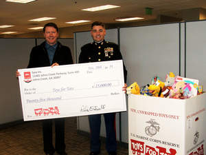 Saia President and CEO Rick O'Dell presented a check to Chief Warrant Officer A.T. Wilson at the onset of the company's Toys for Tots campaign. An internal drive by employees garnered over 4000 toys for the charity.