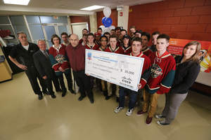 Frank Kicenko, Technical Marketing Engineer, Collaboration, Cisco Canada presented Scott Coates and the Winnipeg Warriors Hockey Club with grand prize of $20,000 for Hockey's Hidden Heroes Contest at Notre Dame Recreation Centre in Winnipeg on Apr. 16, 2015. Canadian Press Images/John Woods