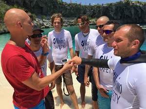 Dr. Stig Severinsen (left) demonstrates Masimo's MightySat fingertip pulse oximeter with the 2015 Vertical Blue freediving safety team.