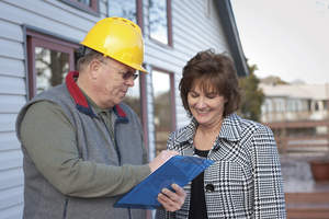 Home contractor discussing with home owner