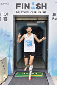 Piotr Lobodzinsky of Poland crosses the finish line with a time of 11 minutes and 8 seconds to win the 2015 Taipei 101 Run Up Race.