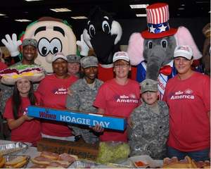 Each year, Wawa associates, mascots, and members of the USO team up in building the massive Hoagie Day hoagie.