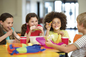 Children eating lunch around a table