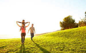 Family walking through the grass.