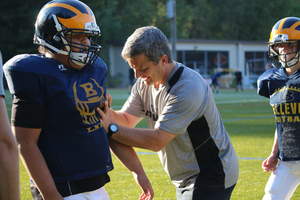 ATAVUS Head of Football Rex Norris demonstrates rugby style tackling technique to a Bellevue (WA) junior football player as part of a program to improve the effectiveness and safety of the game.