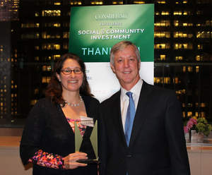 BCG's Wendy Woods and Anthony Banbury, the UN assistant secretary-general for field support who led UNMEER during the Ebola crisis, pose with the award at the dinner.