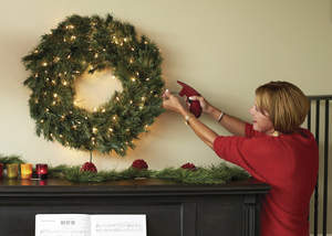 Woman lighting a wreath