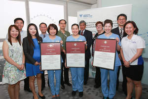 Dr Desmond Yen, Executive Director of ACHSI (third from right, back row) with the Fresenius Medical Care Singapore management and clinical team during the accreditation ceremony.
