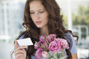 Woman reading a card with flowers