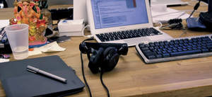 Wacom tablet, laptop and headphones on a desk.
