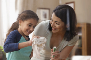 Woman and child cleaning glass