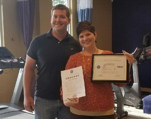Jacob Lease and Martha Kartaoui with her Patriot Award, at the Results Physiotherapy clinic in Cary, NC.
