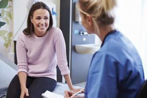 Woman talking to a nurse.