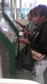 Customer using QPAGOS kiosks for self service payments