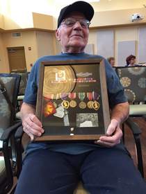 World War II veteran, George Rosenthal  displays his medals following the ceremony.