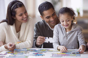 Family working on puzzle