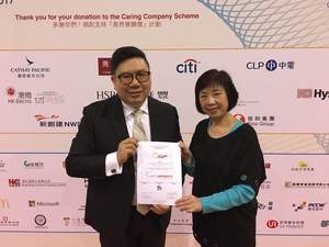 Mr. Tommy Chan and Ms. Catherine Lai from Crown Worldwide (HK) receiving the 15th Years Caring Company Award on stage.