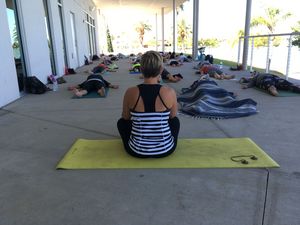 Sherry Duquet, Madeira Beach Yoga instructor and owner, leads clients through savasana, the final resting pose, on the patio.