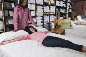 Woman laying on mattress