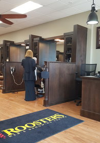 A guest of Roosters Men's Grooming Center in Palm Beach Gardens receives custom grooming services in one of the store's relaxing barber stations. (photo courtesy of Roosters Men's Grooming Center)