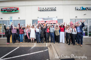 Attendees of Roosters Men's Grooming Center's official ribbon cutting in Torrence Village give an enthusiastic welcome to the new business.