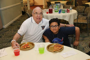 John Carver and student Ryan Albasrawi enjoy pizza during students' field trip to Oakwood Common