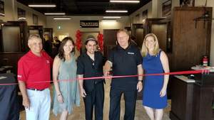 Participating in Roosters Men's Grooming Center official ribbon cutting are, from left to right, Dean Roberts of TSN 1200, Sueling Ching, executive director, West Ottawa Board of Trade; Fadi Abou Rahal, Roosters MGC's team member; Phil Weaver, owner of Roosters MGC; and Kassondra Walters, business development director, West Ottawa Board of Trade.