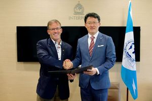 John N. Stewart, Senior Vice President and Chief Security Officer, Cisco, and Noboru Nakatani, Executive Director, INTERPOL Global Complex for Innovation (IGCI), sign collaboration agreement to combat cybercrime.